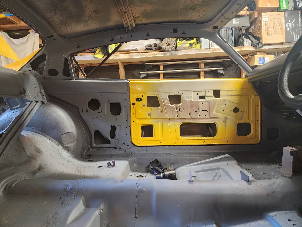 Chrysler Charger interior shell stripped to bare metal and yellow primer — before re-trim at Jay's Auto Trim